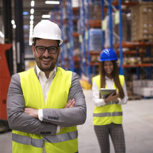 Portrait of successful warehouse worker or supervisor with cross