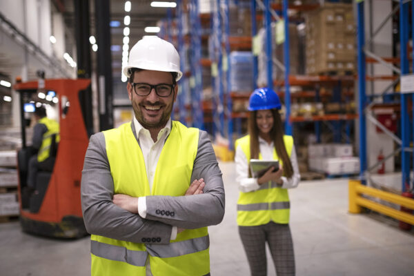 Portrait of successful warehouse worker or supervisor with cross