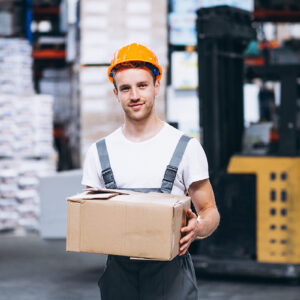 Young man working at a warehouse with boxes