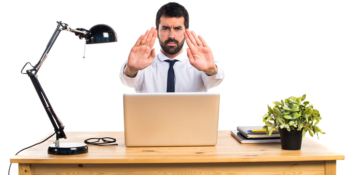 Businessman in his office making stop sign