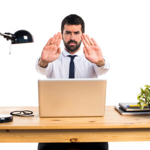 Businessman in his office making stop sign