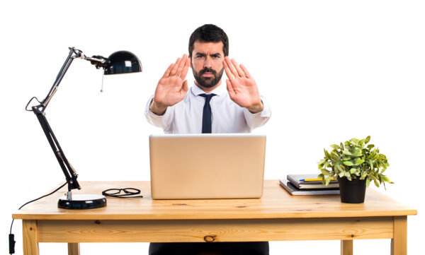 Businessman in his office making stop sign